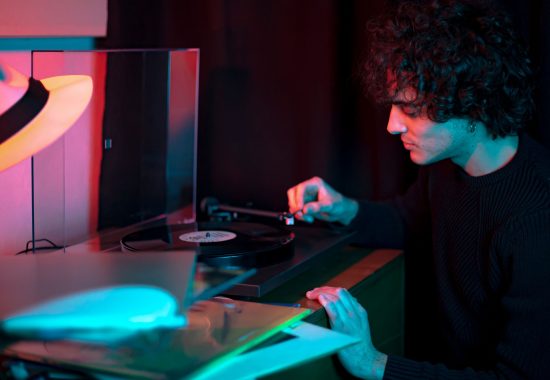 Portrait of young Guy listens to a vinyl record
