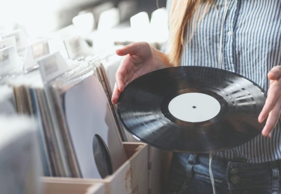 Young woman with music records in a store